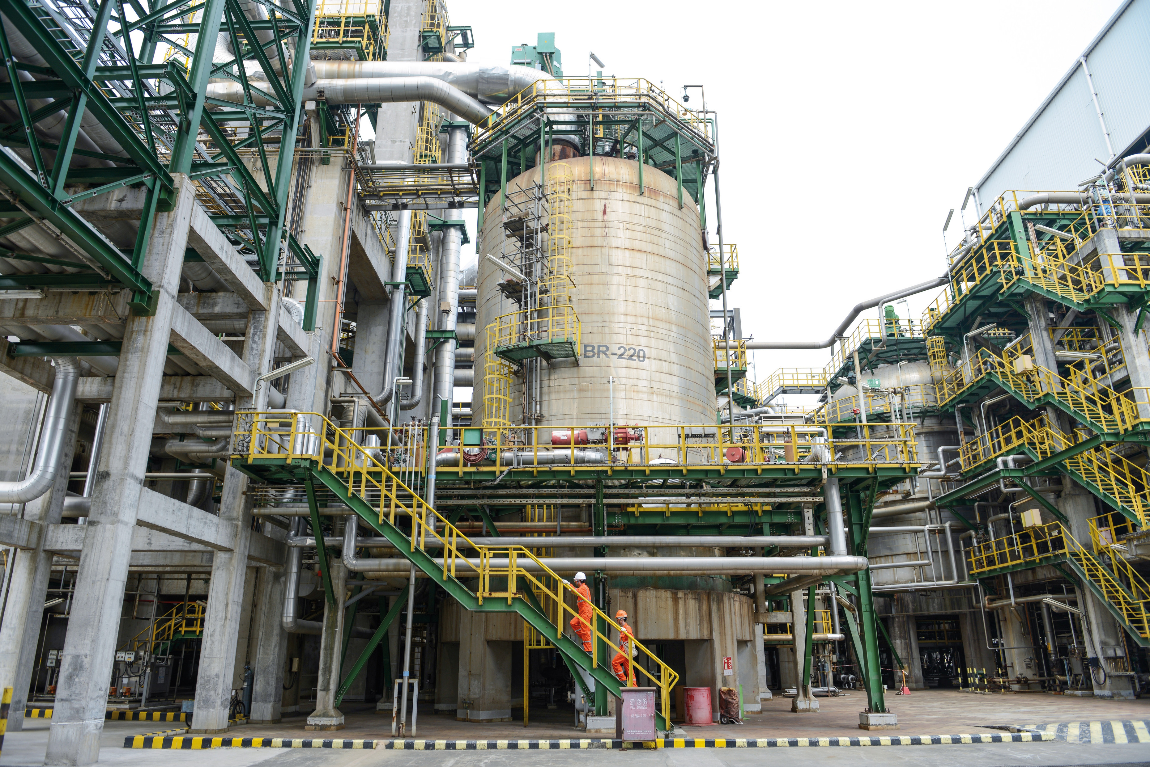 Operators climb stairs to oxidation reactor.jpg